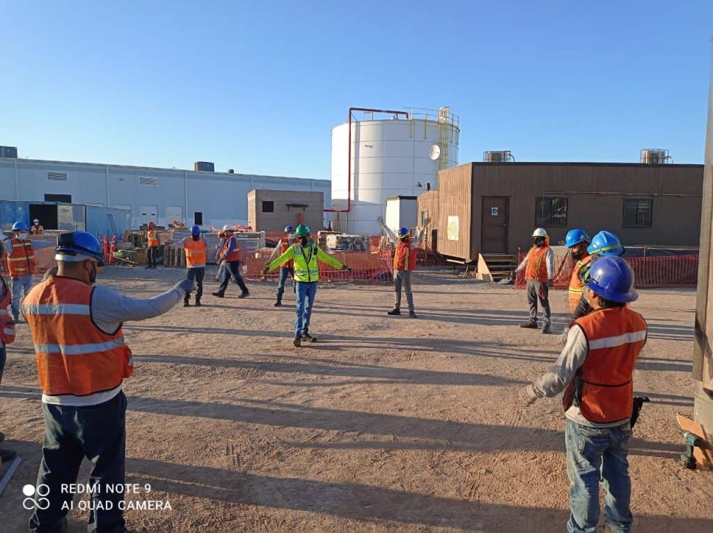 Workers having a 5 minute talk about safety before starting the construction work.